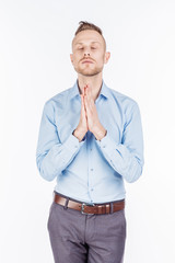 bearded business man praying with hands. human emotion expression and lifestyle concept. image on a white studio background..