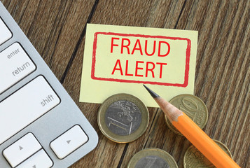 fraud alert concept with money and desk background