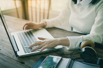 Woman hand typing on laptop keyboard