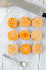 Top view of group of persimmon fruits on white background.