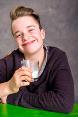 teenager in brown sweatshirt drinking milk