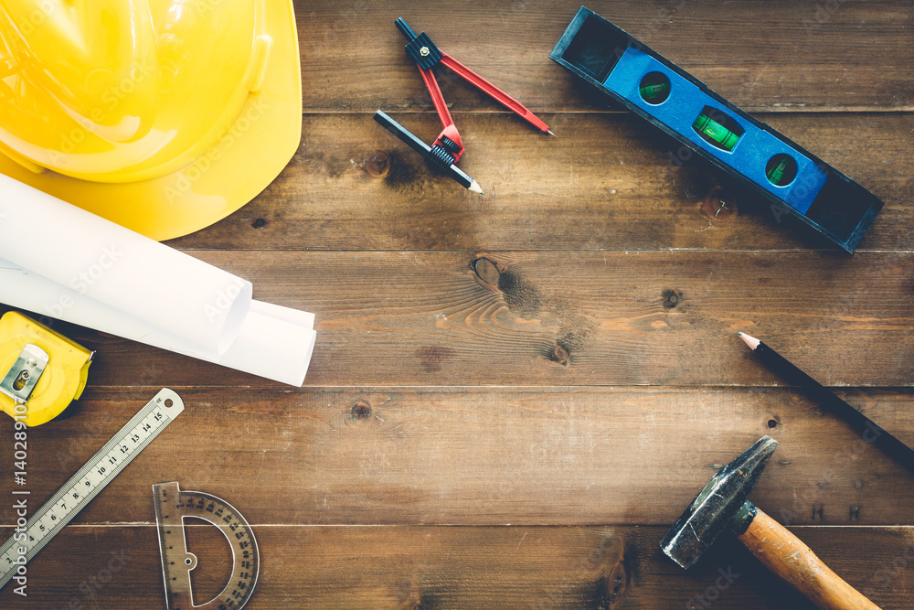 Wall mural construction tools with helmet safety on wooden background