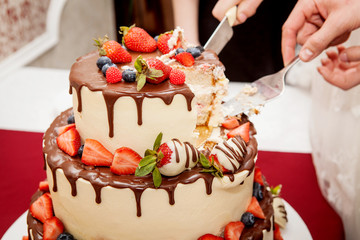Cutting the wedding cake strawberry