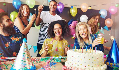 Six young adults celebrating a birthday party