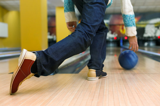 Man throw ball at bowling lane, cropped image