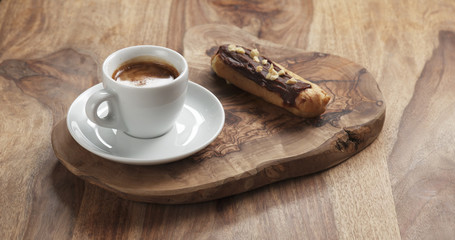 fresh espresso and eclair with hazelnuts, 4k photo