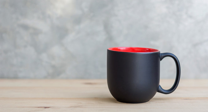 black coffee cup on a wooden background.