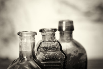 Coloured glass bottles on a rustic background