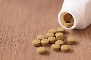 Fototapeta na wymiar herb medicine in pill on wood table