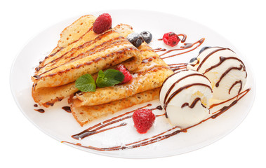 Serving pancakes with ice cream and fresh berries on the plate.