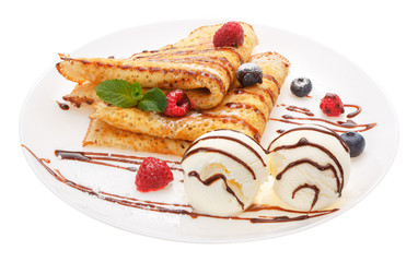 Serving pancakes with ice cream and fresh berries on the plate.
