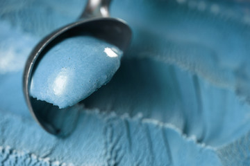 scooping blue ice cream close up shot shallow focus