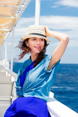 photo of beautiful young woman on the boat in front of sea background in Greece