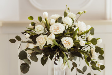 a beautiful bouquet of flowers of white roses eustoma in the interior of the vase is transparent to