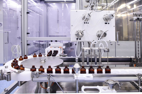 Sterile capsules for injection. Bottles on the bottling line of the pharmaceutical plant. Machine after checking sterile liquids. Interferon, nasoferon.
