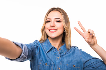 Portrait of a smiling cute woman making selfie photo on smartphone