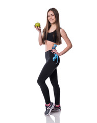 Slim and healthy young woman holding measure tape and apple isolated on white background. Weight loss and diet concept.