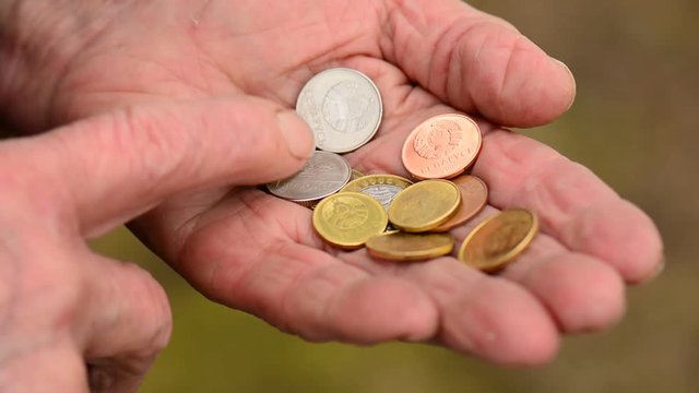 Coins in old woman hands. Elderly woman counting of small change coins. Business poverty concept.