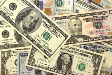 Abstract dollar bills of different denominations background.