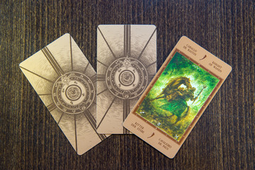 Tarot cards on the wood. Labirinth tarot deck. Esoteric background.