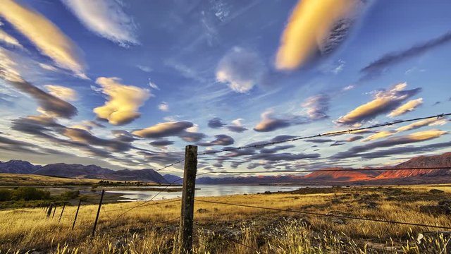Lenticular Clouds Hover over Lake and Mountain Alpine Landscape Timelapse