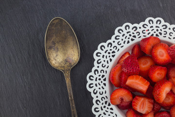 Strawberries on a white plate / Red Freshly cut strawberries on a white artistic plate