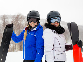 Portrait of two women with skis