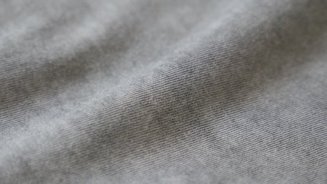 Shallow DOF fine silky cotton smoked grey color t-shirt slow pan 4K 2160p 30fps UltraHD footage - Panning on high quality shiny gray moder fabric 3840X2160 UHD video