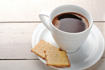 Fototapeta na wymiar black coffee with biscuits on a wooden table