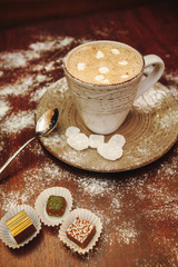 Cup hot cocoa with marshmallows, cookies on a desk with sugar powder for christmas holiday.