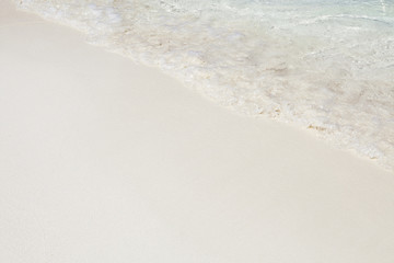 Beach wave on the white sand, tropical background