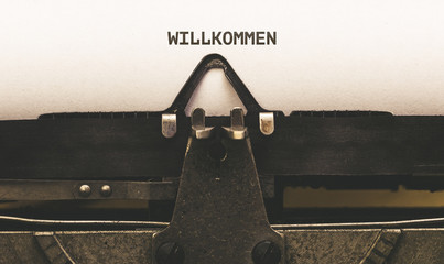 Willkommen, German text for Welcome on vintage type writer from 1920s