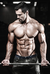 Fototapeta na wymiar Handsome power athletic man on diet training pumping up muscles