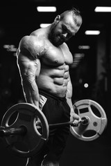 Fototapeta na wymiar Handsome power athletic man on diet training pumping up muscles