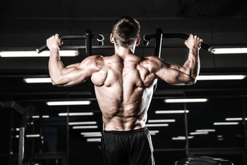 Handsome power athletic man diet training pumping up back muscles