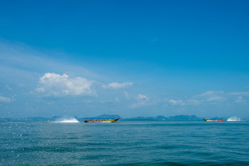 Naklejka na ściany i meble Unidentifiable longtail boats cruising in Phang Nga Bay, Thailand