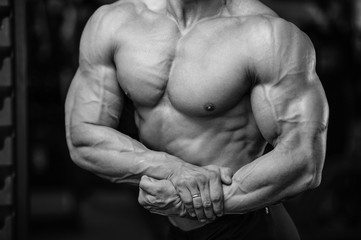 Naklejka premium Handsome power athletic man on diet training pumping up muscles