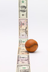 Leather baseball ball and US money  on the white table