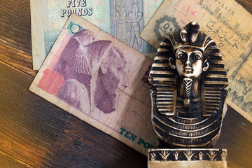 Souvenir sculpture of the Egyptian pharaoh on the money background
