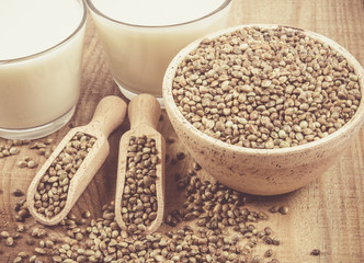 Hemp milk, seeds on wooden background . Close Up .
