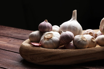 Garlic. Garlic Cloves and Garlic Bulb in vintage wooden bowl.