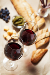 Red wine with charcuterie assortment on the background
