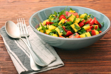 Mango salad with pepper and parsley in a bowl. Healthy low fat detox eating concept.