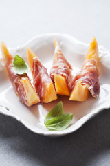 Slices of cantaloupe melon and prosciutto ham, shallow DOF