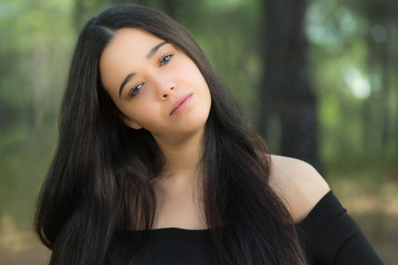 Fototapeta premium Portrait of young woman in a forest