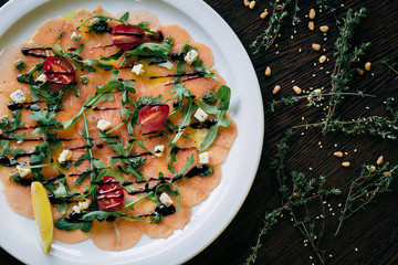 Salmon carpaccio in a white plate