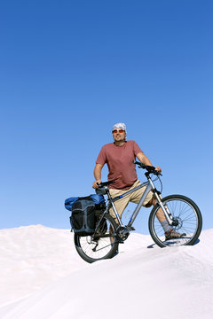 Traveling man on a bicycle in the desert. © trek6500