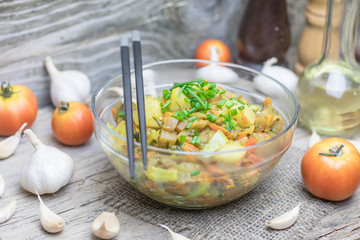 Homemade nutritional vegetable ragout in glass plate bowl on rustic old wooden table. Vegan or vegetarian food diet. Selective focus.