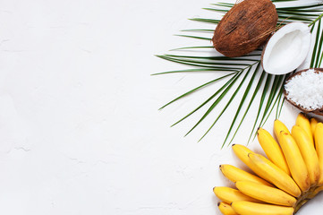 White background whith bananas, coconuts and palm leaf