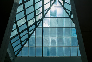 Sunlight pushing through tinted glass in pyramid roof structure